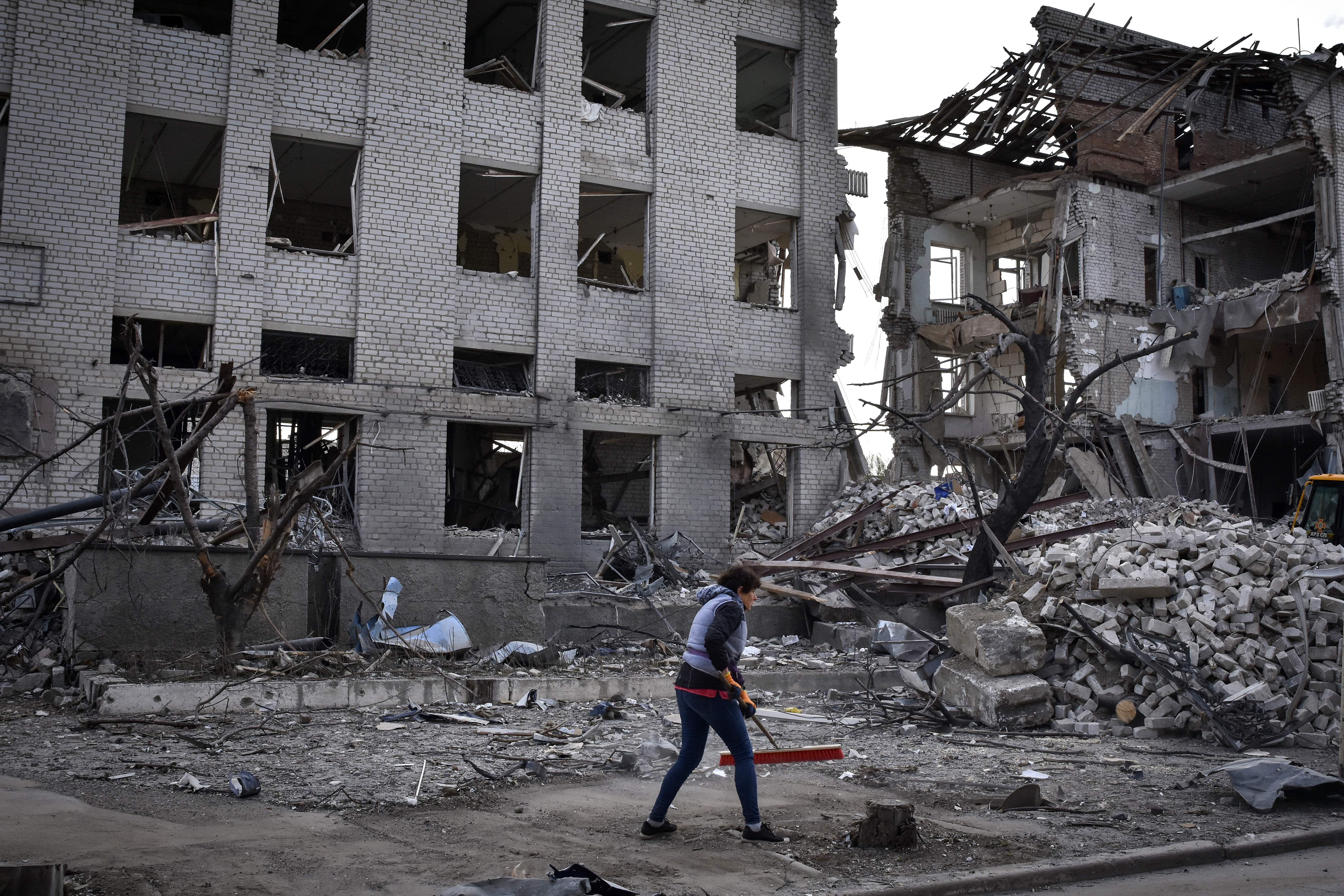 A person removes the rubble of a building in the Zaporizhia region damaged by a Russian airstrike. This photo was taken in April.