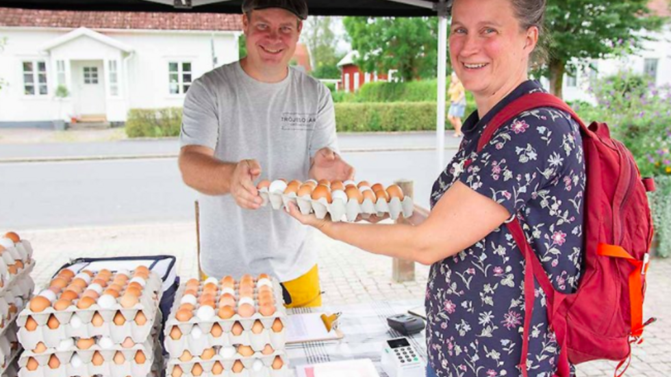 Per Wackt säljer ägg till Lina Larsson, miljöstrateg på Vaggeryds kommun. Bild: Vaggeryds kommun.