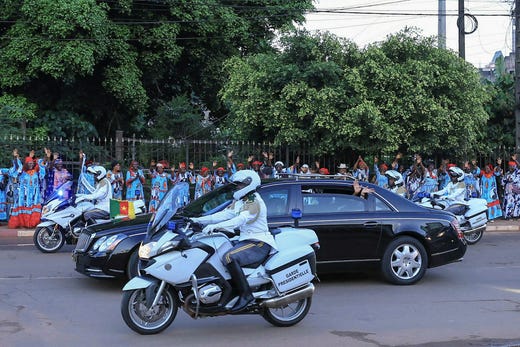 First Lady Chantal Biya waves to ruling party supporters who welcomed the elderly leader back to the capital after a six-week absence.