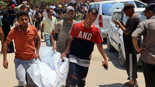 A person transports a body from the Nasser Hospital morgue.