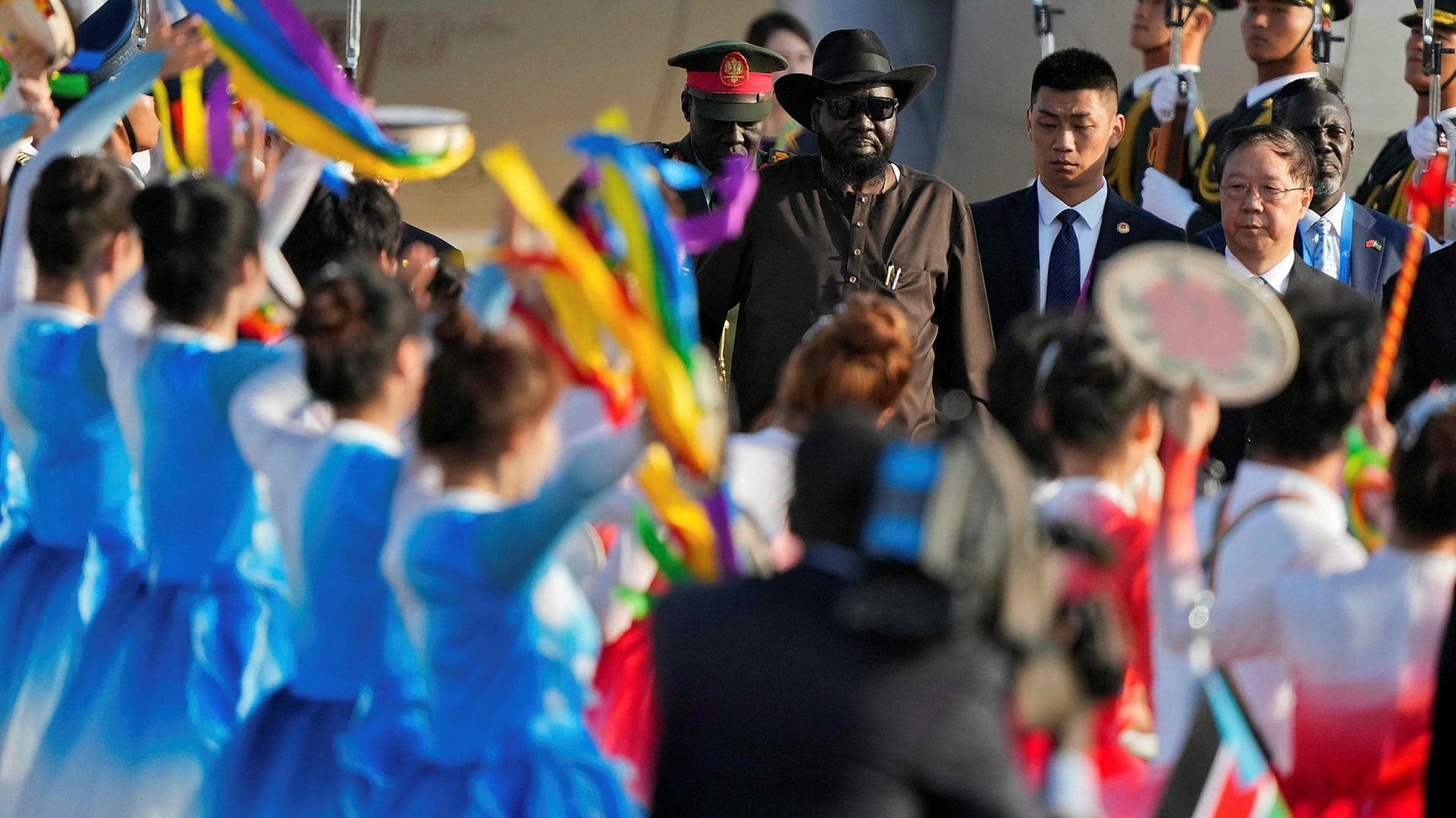 South Sudan President Salva Kiir is welcomed at Beijing airport. He and other African leaders will attend a summit with China Wednesday-Friday.