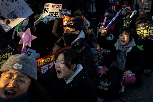 Unga kvinnor som bär färgglada, lysande k-pop-pinnar har spelat en dominerande roll i protesterna som har rasat i Sydkorea sedan president Yoon Sok-Yeol skakade landet genom att införa nödlagar. Presidenten ska nu ställas inför riksrätt.