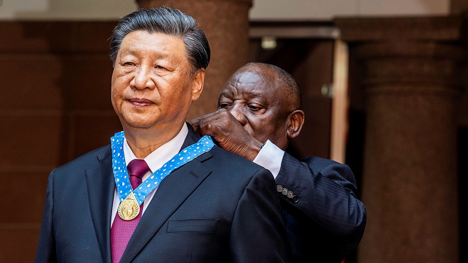 South African President Cyril Ramaphosa hangs a medal around his Chinese counterpart Xi Jinping's neck during a state visit last year.