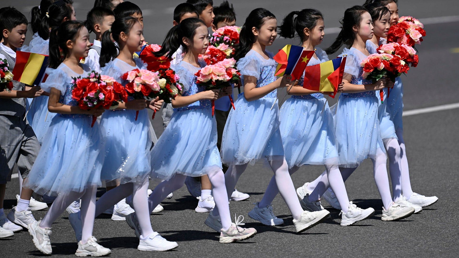 Chinese children get ready to welcome Chadian President Mahamat Idriss Deby to Beijing. He and many other African leaders are in the Chinese capital to attend a summit with China's leaders.