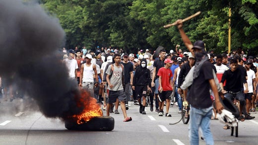 Protesters set fire to cars, tires and garbage in the streets.