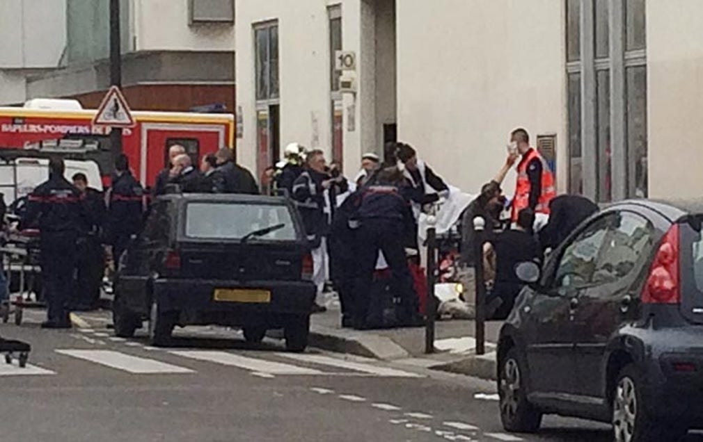 Polis och brandkår utanför Charlie Hebdos redaktion i Paris.