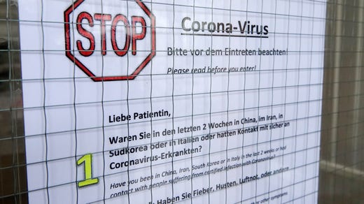 En skylt utanför ett sjukhus i Hamburg ger instruktioner till patienter som varit i högriskområden.