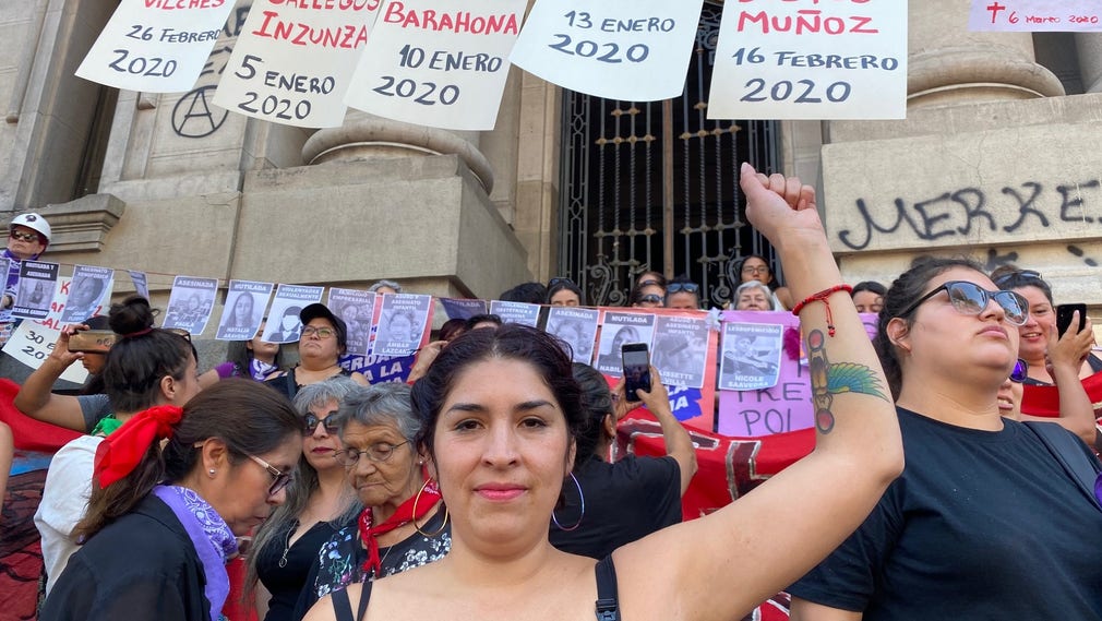 Mariana Gutierrez, 34, på trappan till Nationalbiblioteket under en banderoll med namn på de sju kvinnor som hittills mördats av sina män under 2020.